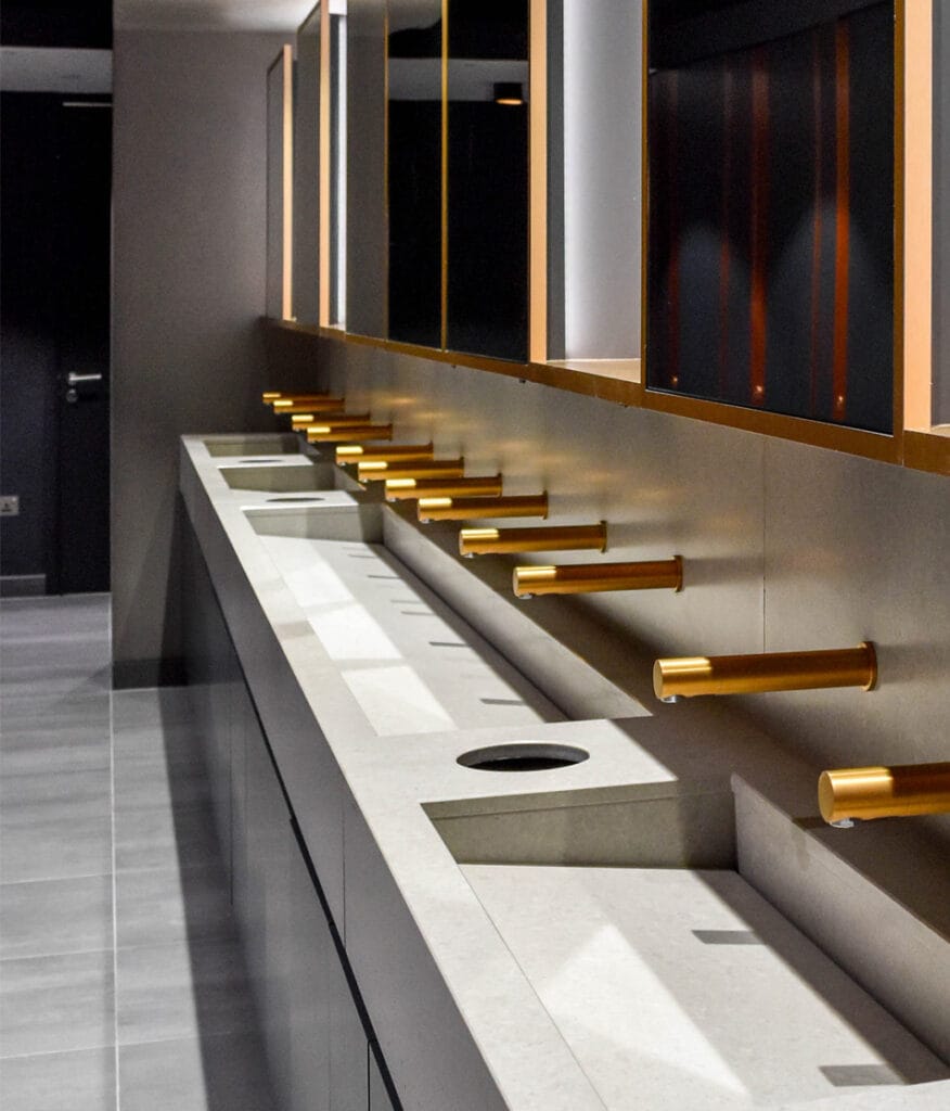 Eco-friendly washroom products - touch-free taps in gold finish and behind--the-mirror SMART system