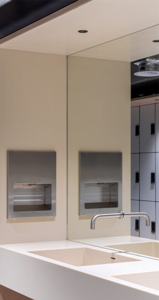 Commercial low energy hand dryer and sensor tap as part of green building trends in washrooms 2023