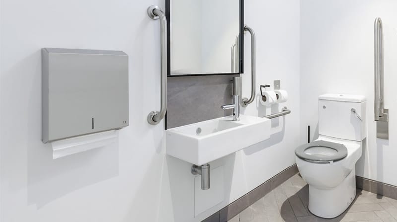 Ambulant superloo with drop-down rail and hand rinse basin