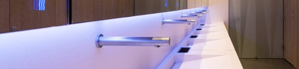 Touch-free taps in a commercial washroom