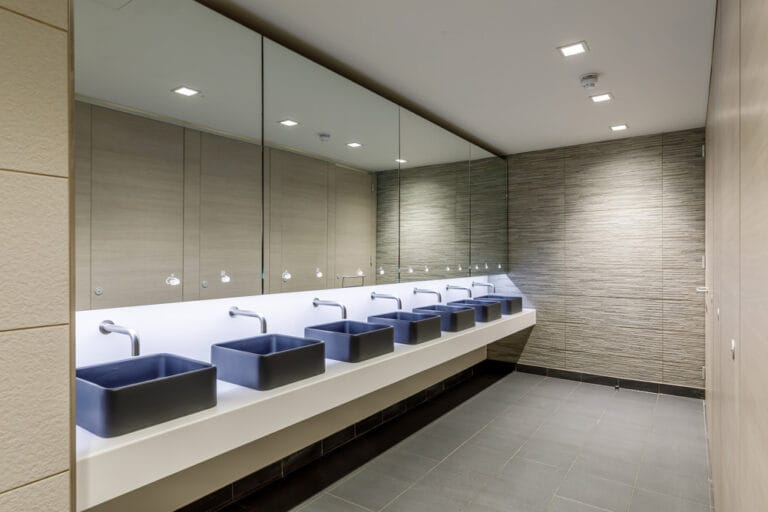 Dolphin ALAVO behind-mirror washwall system and SMART sensor taps in commercial washroom