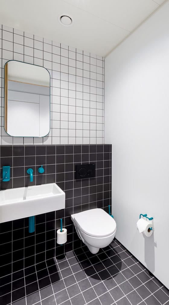 Cost and water saving wall hung WC pan equipped with delayed action inlet valve