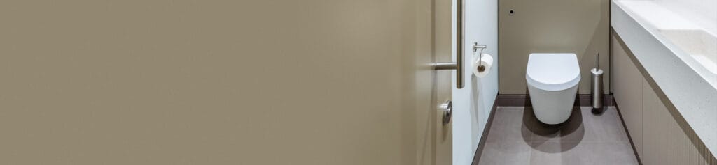 WC pan equipped with a delayed action inlet valve in a commercial Superloo washroom