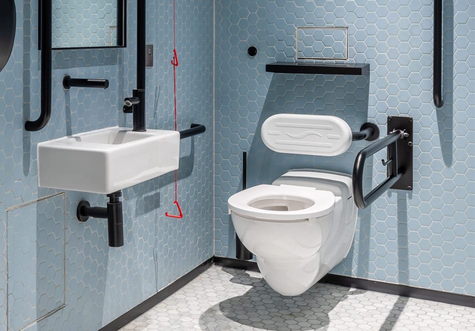 Wall-hung Doc M toilet pan with black washroom fittings