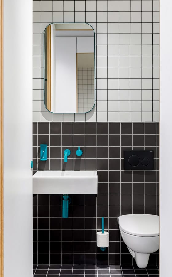 Teal coloured sustainable finish seen on this manual tap, toilet roll holder, and other washroom products
