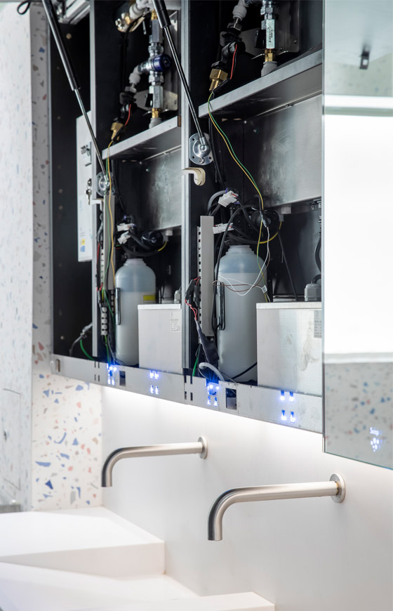 Inside the Alavo behind mirror system, with accesss to the taps, water feeds, soap feeds, and more