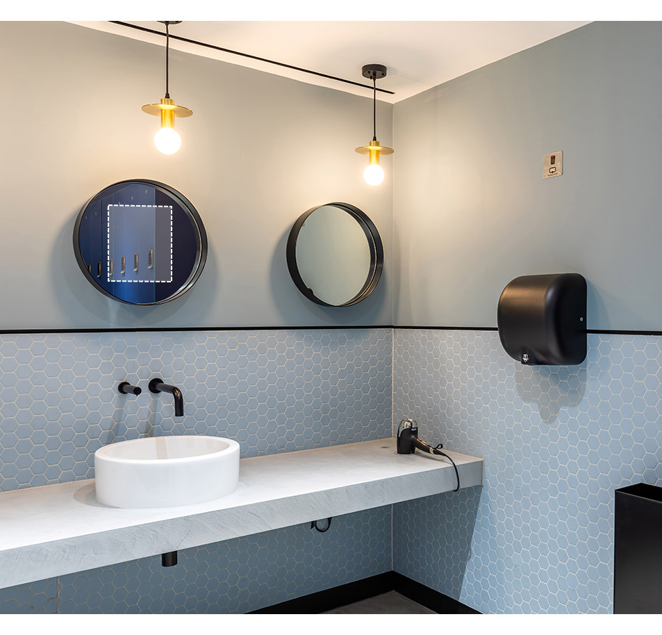End-of-trip facility with black finished washroom products and access panel behind the round mirror