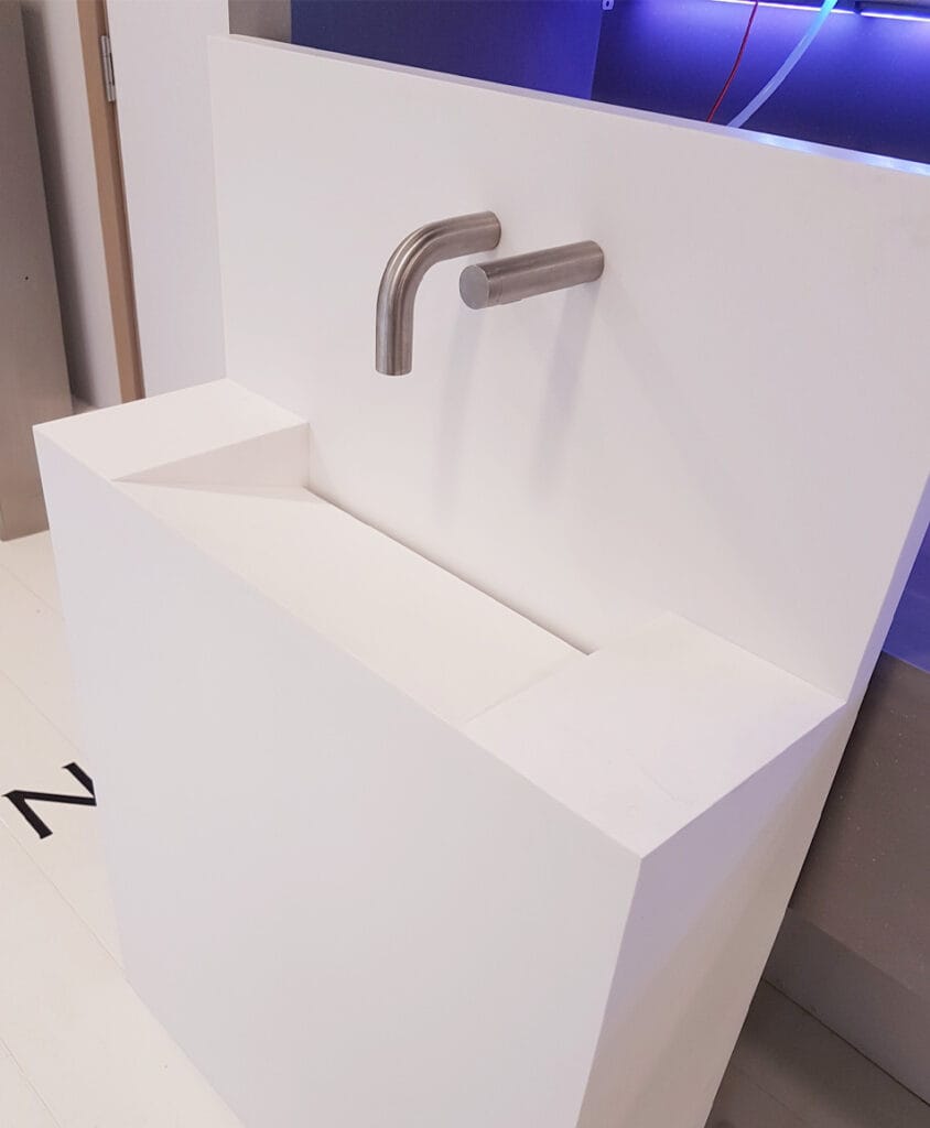 Washstation designed with Unico Vanity Trough, Inform Smart Tap, and touch-free soap dispenser