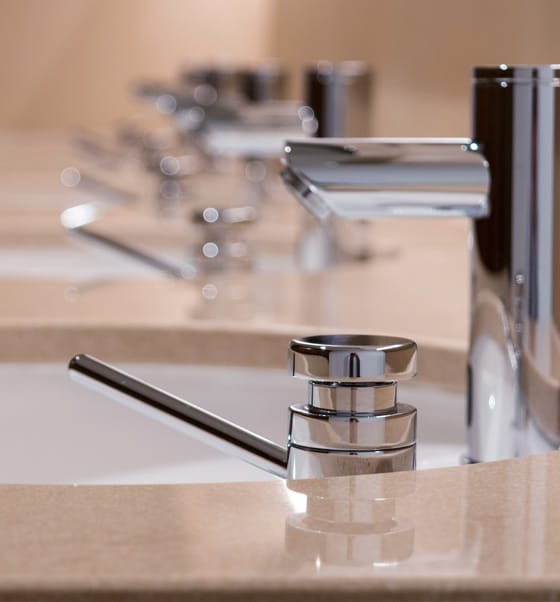 Counter top row of infrared taps and Dolphin Prestige DP 1203 Top Fill Liquid Soap Dispensers