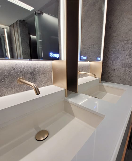 Hand basin and wash trough with matching gold taps and waste trap