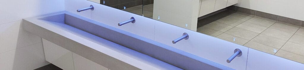 Dolphin Alavo with vanity units, wash troughs, and touch free taps