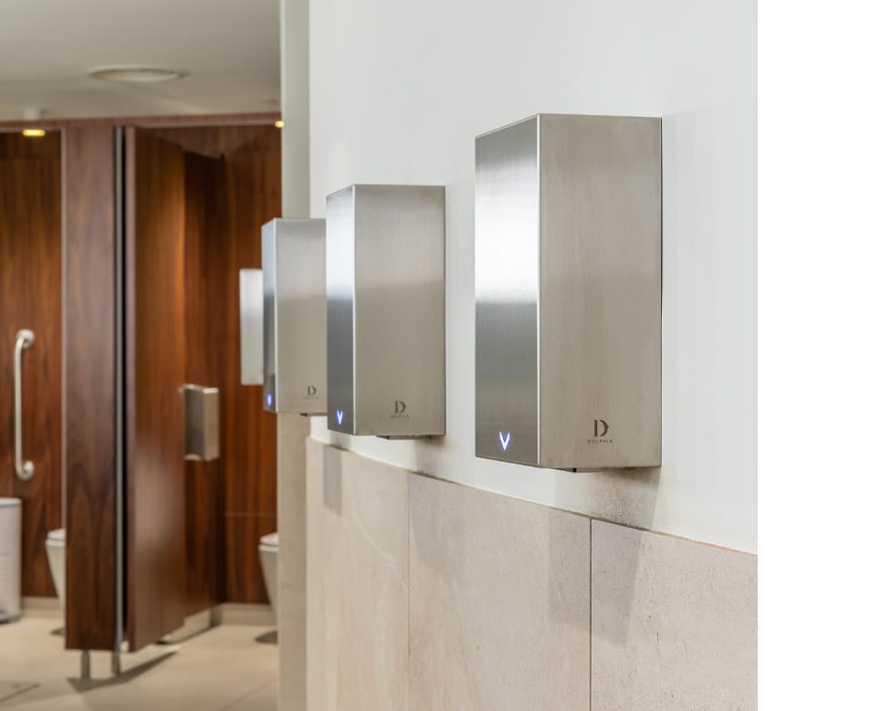 Three eco-friendly low energy hand dryers in a public washroom