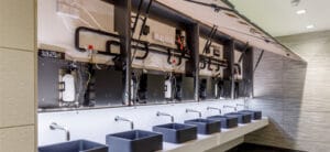 Behind mirror system installed with a refillable soap dispensers
