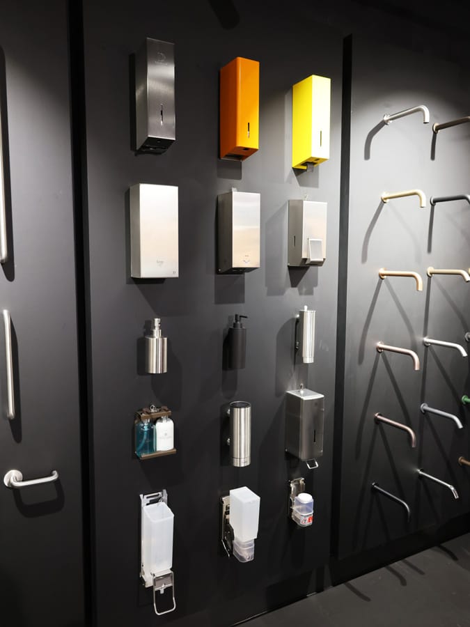 Wall display of various commercial washroom accessories and fittings