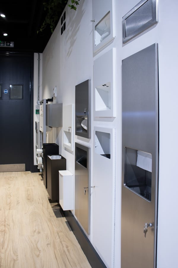 An aisle of commercial combination units and waste bins
