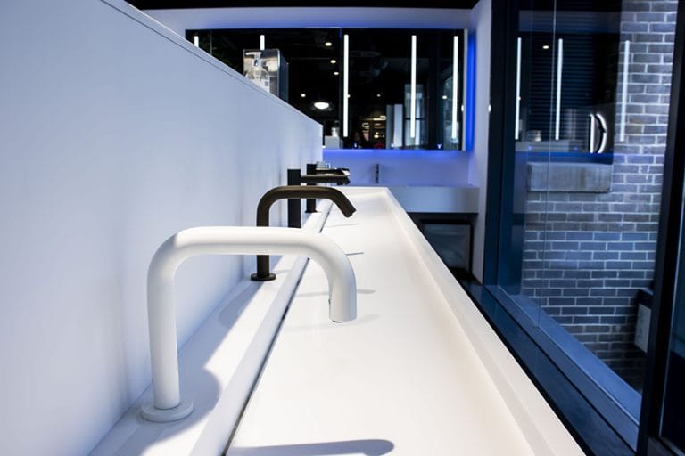 Angled touch-free taps shown in different finishes