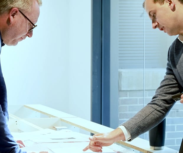 A Dolphin Solutions staff member explaining something to a client