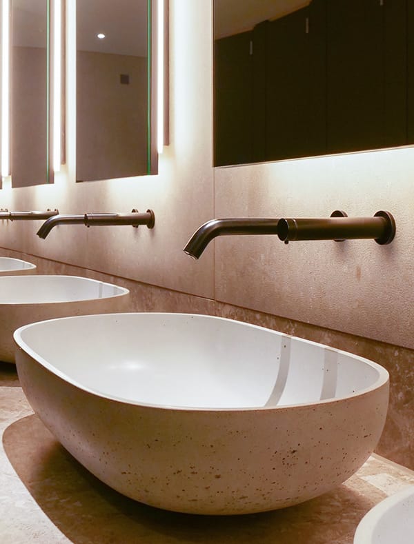 A special finished slimline tap and touch-free soap dispenser at Ilona Rose House by Dolphin Solutions