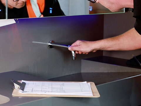 Dolphin Staff inspecting a sensor tap