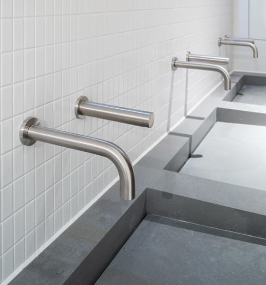 Stainless steel finish on washroom taps and soap dispensers