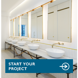 Row of touch-free gold taps and soap dispensers