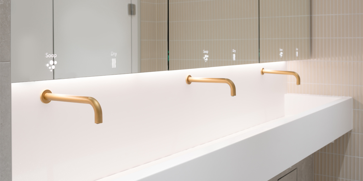 Gold finished SMART touch-free taps, with Dolphin WashWall System
