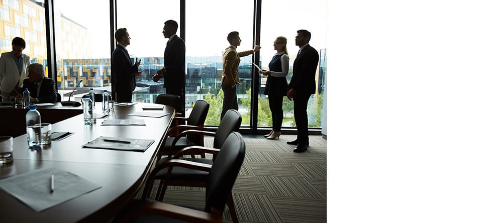 people discussing inside a boardroom